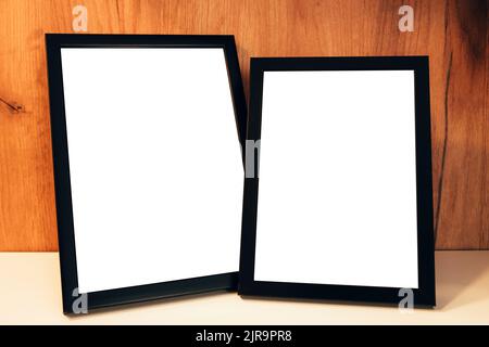 Two blank picture frames on the shelf as mockup copy space for graphic or text Stock Photo