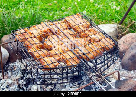 Chicken white meat barbecue frying on a country grill. Stock Photo