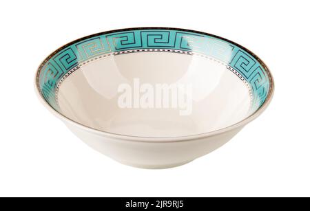 White deep dish with turquoise border cutout. Porcelain bowl decorated with a golden meander ornament on a blue border. Empty crockery isolated. Stock Photo