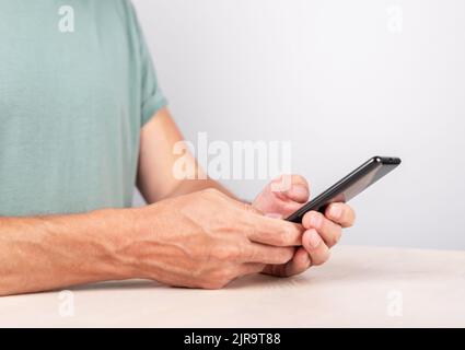 Man hands closeup texting message at smartphone. Male using messenger. Device for social communication. High quality photo Stock Photo