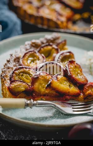 Close up shot of a sweet plum pie piece served on a plate Stock Photo