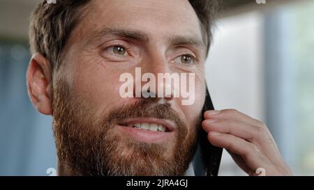 Smiling 40s happy adult professional cheerful businessman with toothy smile making business call talking phone in office agree say Caucasian bearded Stock Photo