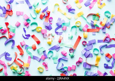 Colorful paper confetti on blue background. Stock Photo