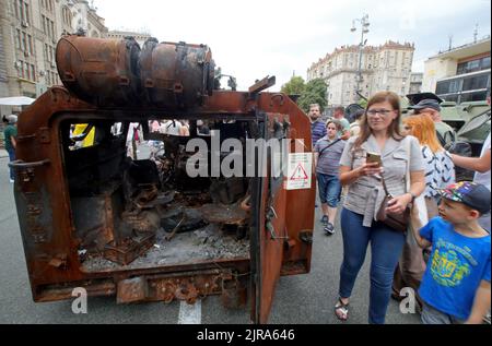 Non Exclusive: KYIV, UKRAINE - AUGUST 20, 2022 - People look at the destroyed russian military equipment displayed at the exhibition dedicated to the Stock Photo