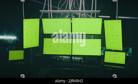 Computers and monitors for cyber crimes and cyber attacks on a desk in a hackers dim room with lamps Stock Photo
