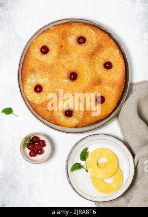 Delicious pineapple upside down cake with candied cherries. Homemade summer tropical dessert. Flat lay. Stock Photo