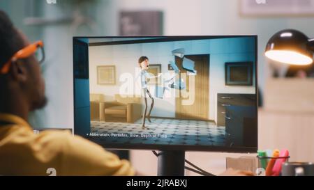Black man in glasses rendering 3D cartoon on computer while working in home office Stock Photo