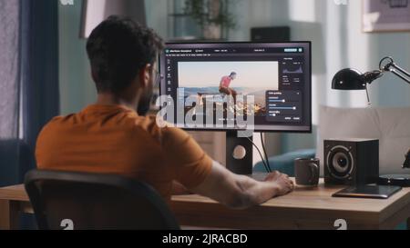 Anonymous male using computer to integrate 3D graphic into footage with real man during work in home office Stock Photo