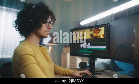 Male freelancer in casual clothes and glasses using software on computer to edit video during work in home office Stock Photo