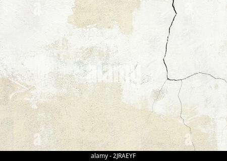 White plaster wall texture with crack background. Pattern of white plaster wall in rough aged structure Stock Photo