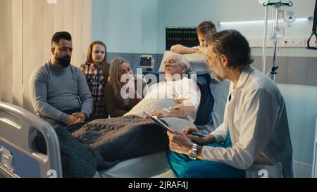 Mature medical practitioner asking questions to aged patient and family and writing on clipboard in ward of modern clinic Stock Photo