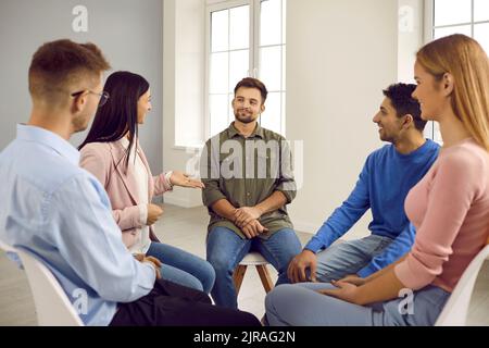 Diverse people sit in circle have counseling session Stock Photo