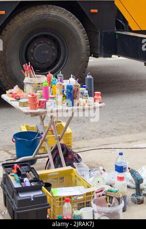 Close-up of a table full of paint cans on which a street artist painter works Stock Photo