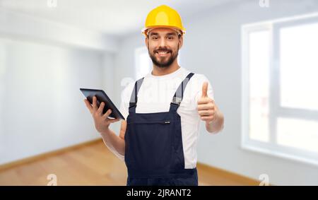 worker or builder with tablet pc showing thumbs up Stock Photo