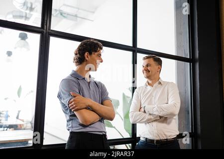 Young businessman talking with colleague in office Stock Photo