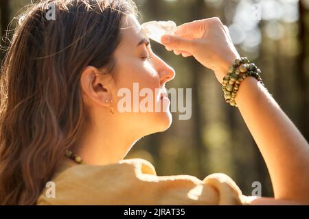 woman or witch performing magic ritual in forest Stock Photo