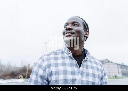 Happy young man looking up at sky Stock Photo
