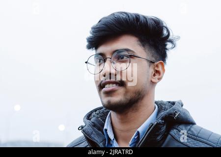 Smiling young man wearing eyeglasses Stock Photo