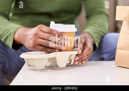 close up of man with takeaway coffee and food Stock Photo