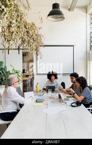 Multiracial colleagues planning and working together at office Stock Photo