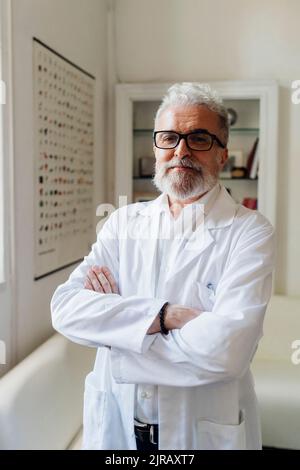 Confident healthcare worker standing with arms crossed Stock Photo
