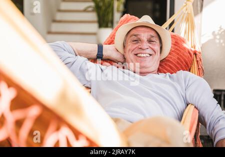 Happy man relaxing in hammock Stock Photo