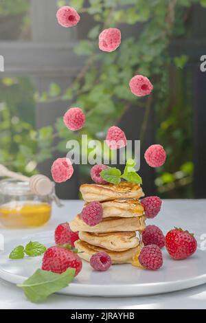 Pancakes with wild berries on the table. Healthy breakfast. Stock Photo