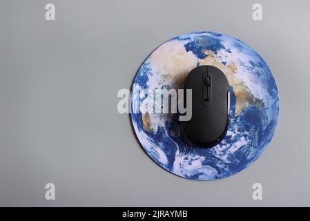 Computer mouse and globe. Internet, global business network, digital technology concept. Stock Photo