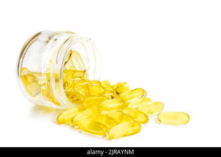 Pile of softgels capsules Omega 3 in bottle isolated on white background. Close up with copy space Stock Photo