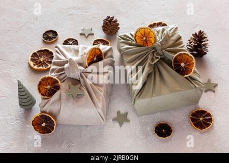 Christmas gifts textile packed, decorated with natural materials, zero waste concept Stock Photo