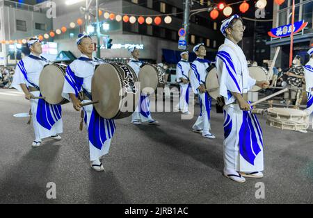 Tokushima, Japan - August 12, 2022: Taiko drummers march in procession at Awaodori street festival Stock Photo