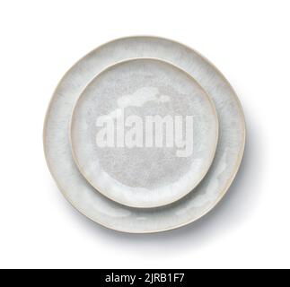 Top view of two empty handmade trendy ceramic plates isolated on white Stock Photo