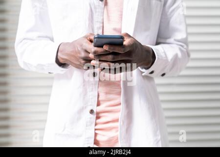 Young man text messaging through smart phone Stock Photo