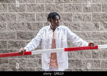 Thoughtful man standing by railing Stock Photo