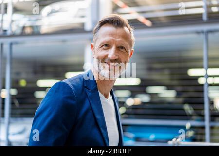 Smiling mature businessman wearing blazer Stock Photo