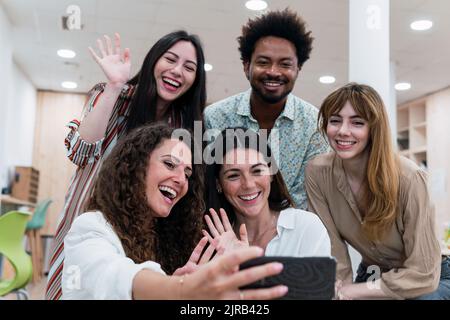 Happy business team taking selfie in office Stock Photo