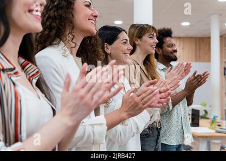 Happy business team clapping hands after a presentation in office Stock Photo