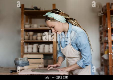 Potter working in art studio Stock Photo