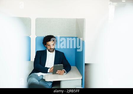 Businessman using tablet computer at workplace Stock Photo