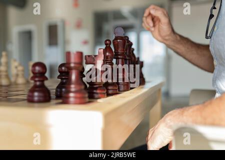 Businessman playing chess in office Stock Photo