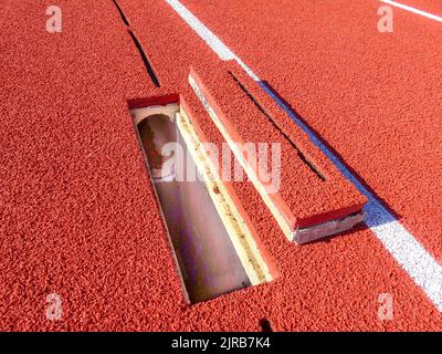 Track Clean Out Example of a new running track with slot drain cleanout with cover ...