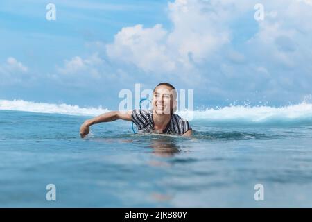 Happy woman swimming in sea on sunny day Stock Photo