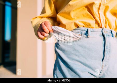 Woman showing empty pocket of jeans Stock Photo