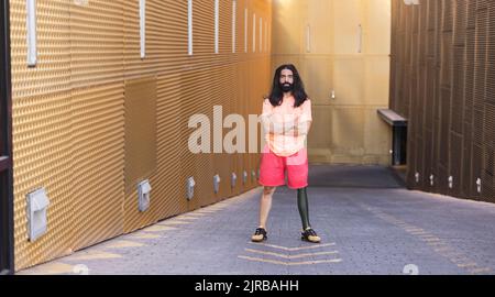 Bearded man with prosthetic leg standing on road Stock Photo