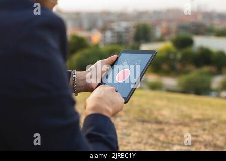 Businessman using home automation app on tablet PC at sunset Stock Photo