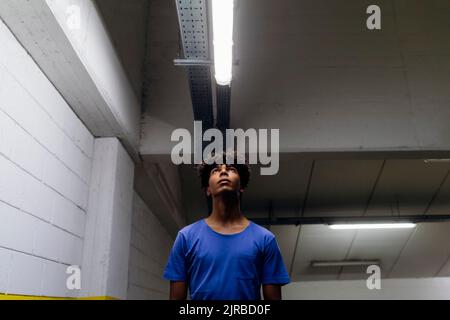Thoughtful man looking at LED Light in subway Stock Photo
