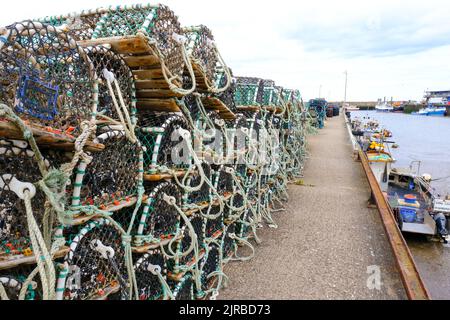 Fishing creels line the harbour side in the Yorkshire resort of Bridlington. Stock Photo