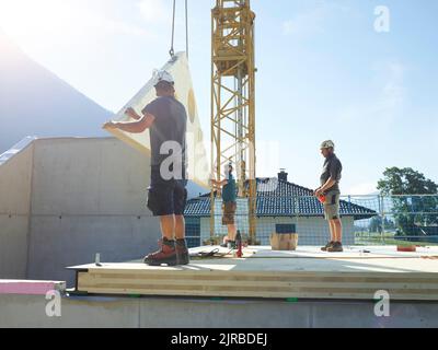 Carpenters working at construction site on sunny day Stock Photo