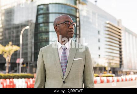 Mature businessman with eyeglasses in financial district Stock Photo
