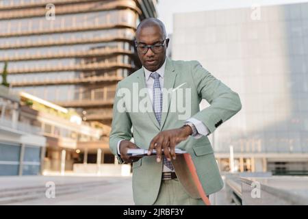 Businessman with documents at financial district Stock Photo
